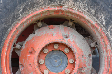 Old rusty nuts and bolt joint on tractor wheel.