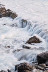 Water flow motion over rocks during big swell in Australia