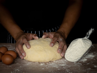 Cook is creating a dough to make bread.
