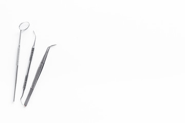 stomatologist instruments on white doctor's office desk background top view mock-up