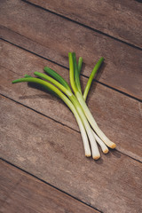 Japanese fresh green scallion or onion on wooden table background
