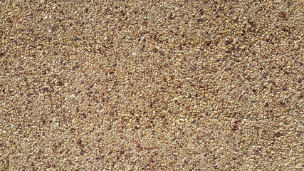 surface structure created by spraying, sifted sand painted crimson and cream small stones, building facades, wall, small texture