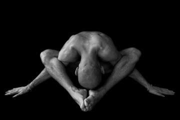 Naked man body doing yoga pose