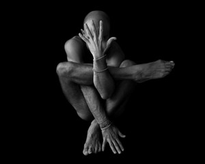 Naked man body doing yoga pose