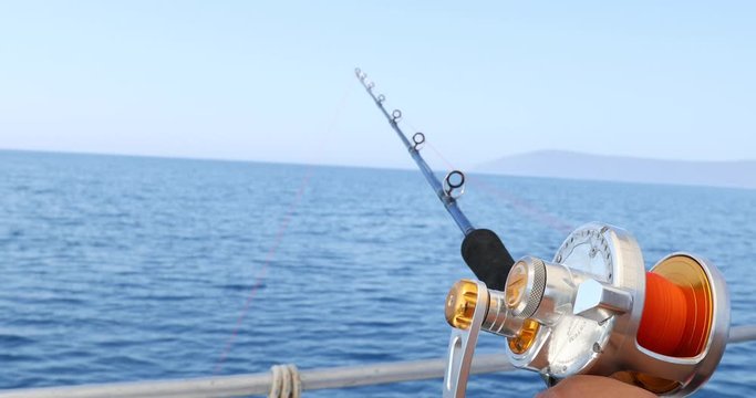 Spinning rod in front of deep sea water