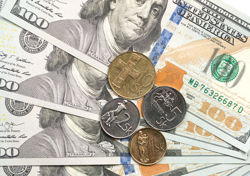 slovak coin on top of dollar bills