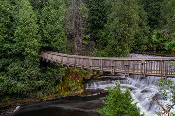 waterfall at belfountain conservation area Ontario Canada with trees, rocks, bridge, and long exposure