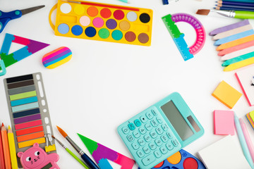 School supplies. Set of colorful school accessories isolated on the white table.