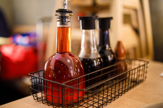 Chilli Oil, Soya Sauce etc in Bottles on a Table