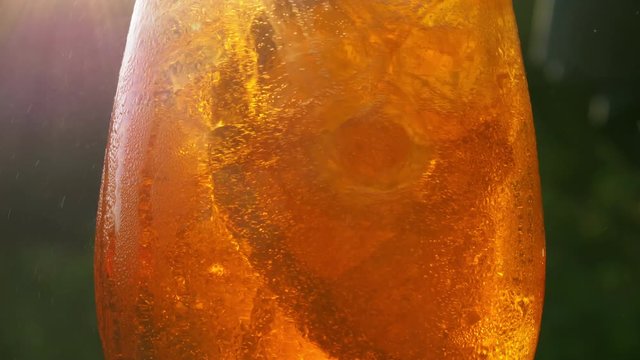 Refreshing orange drink in the sun - 4K 60fps