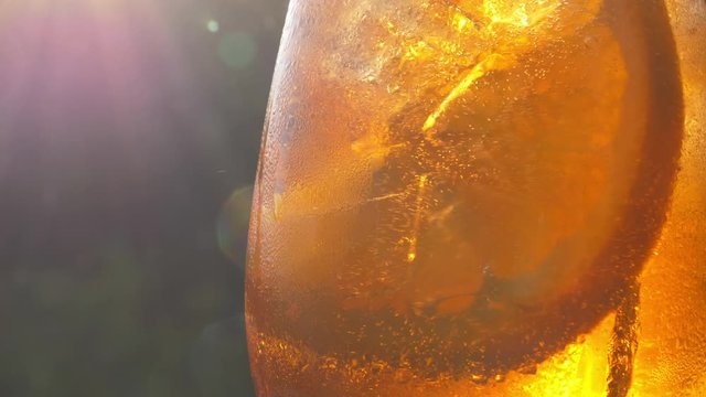 Refreshing orange drink in the sun - 4K 60fps