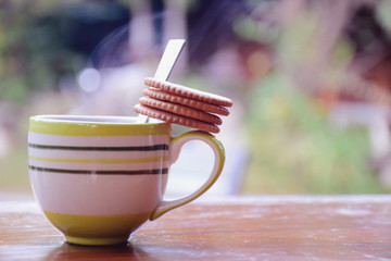 Cup of coffee with cracker