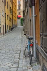 Bicycle on a cobblestone alleyway, quaint street in Gamla Stan, Stockholm, Sweden