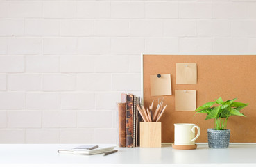 Mockup workspace desk and copy space books,plant and coffee on white desk.