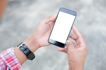 Cropped shot view of man hands holding smart phone with blank copy space screen for your text message or information content, female reading text message on cell telephone during in urban setting. 
