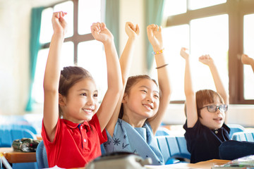 Smiling elementary school kids  in classroom