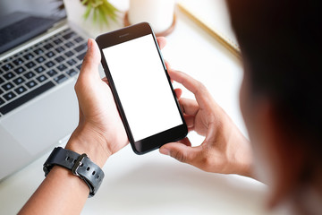 Cropped shot view of man hands holding smart phone with blank copy space screen for your text message or information content, female reading text message on cell telephone during in urban setting. 