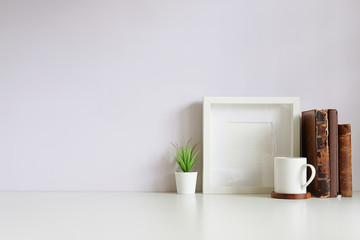 Mockup workspace desk and copy space books,plant and coffee on white desk.