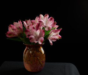 flowers in a vase on black background