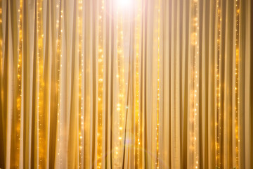 Big Gold Fabric Curtain drape in shape hanging with LED light to make pop up from background with...