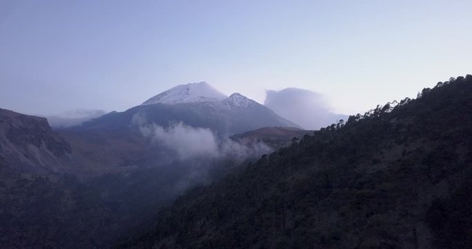 Drone footage of Pico de Orizaba, the third tallest peak in North America, located in Mexico. Smooth flying towards the mountain near sunset.