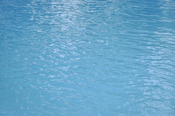 Fototapeta na wymiar Blue swimming pool edge with refection of water ripple