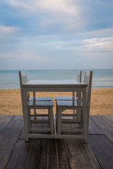 White table for dinner on the beach and sky