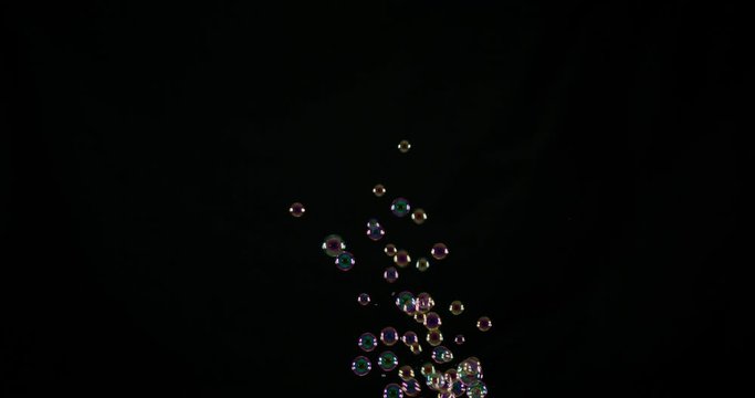 Rainbow soap bubbles on black background