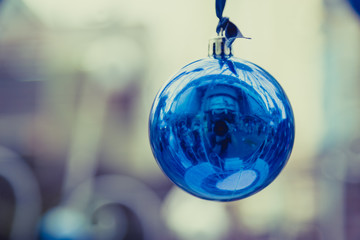 Christmas balls hanging on ribbon with bokeh