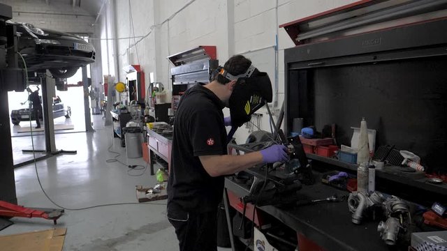welding in slow motion in a mechanic garage