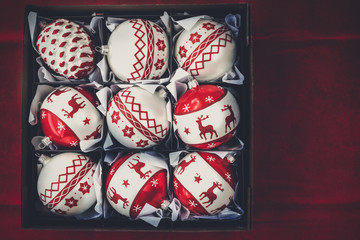 Christmas Decorations. Box with Christmas Decorations on Dark Red Vintage Background, View From Above
