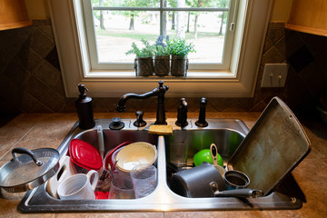 Dirty dishes stacked in the kitchen sink