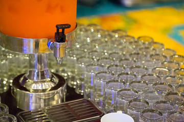 Many glasses with  orange juice on buffet table