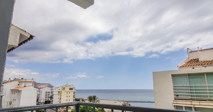 Dreamy cloudy sky with view of apartments, mountain, beach and sea. Echo effect.