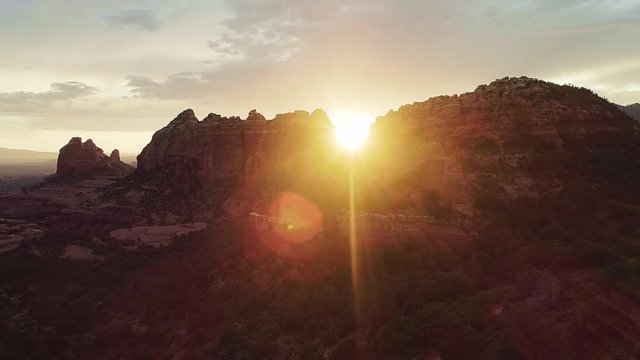 Cinematic Drone Flyover of Sedona Red Rock Mountains and National Forest at Sunrise / Sunset