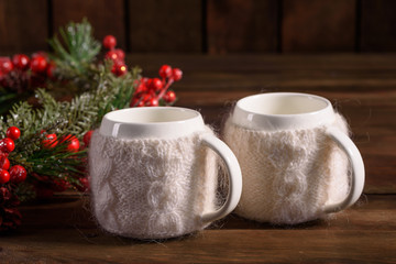 Christmas holiday table with cups for fragrant tea. Eve of new year, preparation and laying of a wooden holiday table