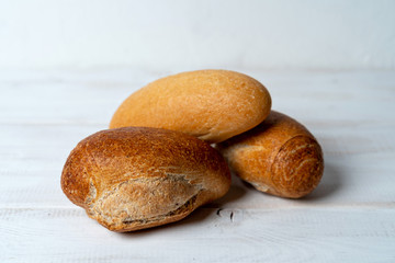 rye and wheat baguettes on white wooden table