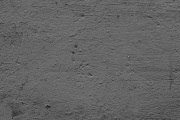 Texture of a concrete wall with cracks and scratches which can be used as a background