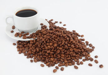 cup of coffee with beans on white background
