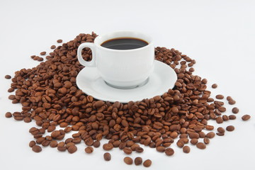 cup of coffee with beans on white background