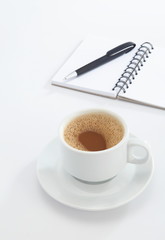 cup of coffee and pen on white background