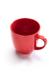 red ceramic mug on white background