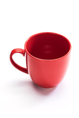 red ceramic mug on white background