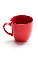 red ceramic mug on white background
