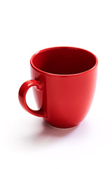 red ceramic mug on white background