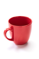 red ceramic mug on white background