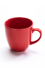 red ceramic mug on white background