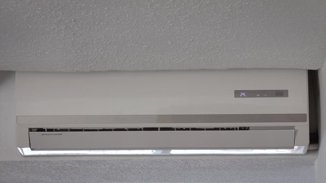 Close up of air conditioning unit turning on.