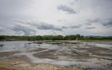 Panorama of hot springs, boiling mud pools and warm toxic lakes in Uzon caldera. Kronotsky Nature Reserve in Russian far east, Kamchatka peninsula. Protected environment . Access by helicopter only.