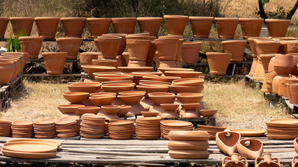 Huge clay jugs in the sun . Clay products trade